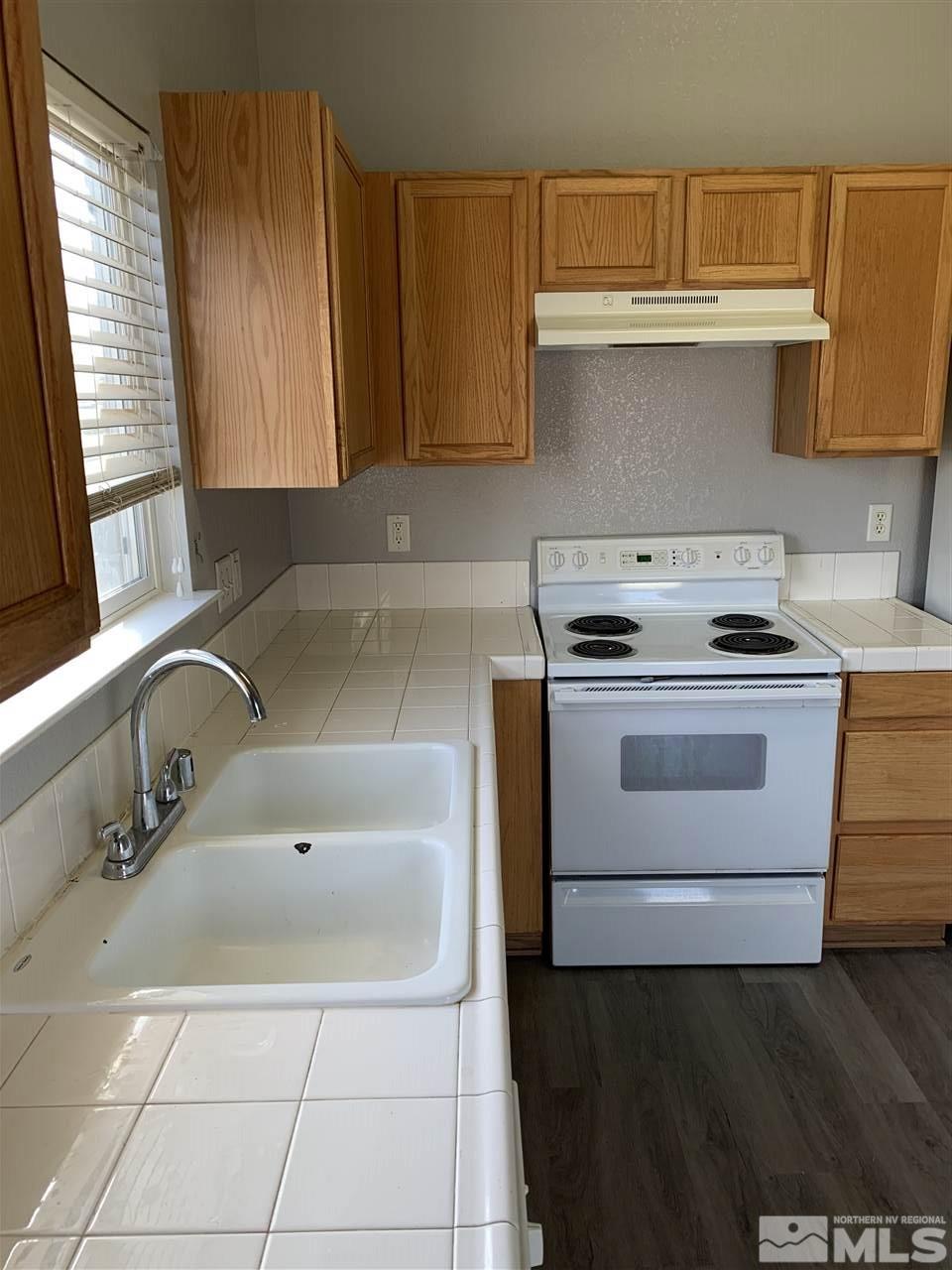 3035 Bryan Street Reno, NV 89503 - Photo 4 of 16 a kitchen with a sink stove and cabinets