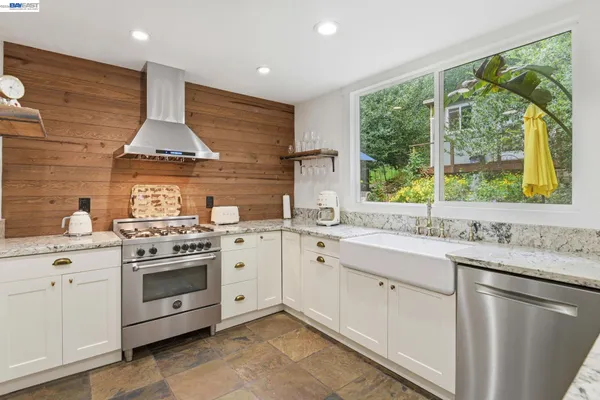 a kitchen with a stove sink and window