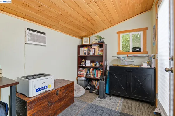 a living room with hard wood floors and a window