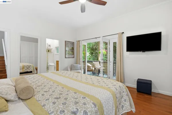 a bedroom with a large bed and a flat screen tv