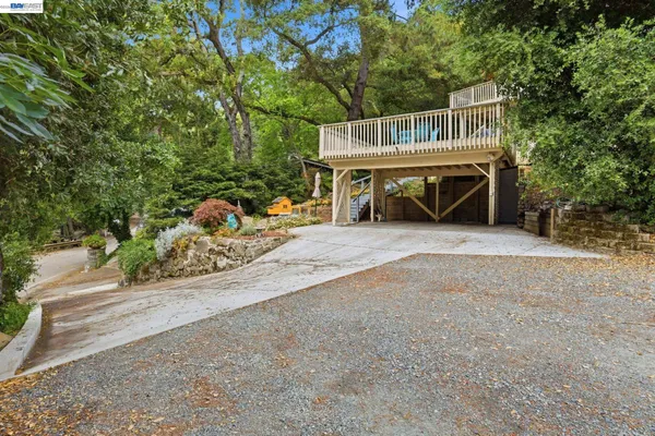 a view of a house with a deck and a yard