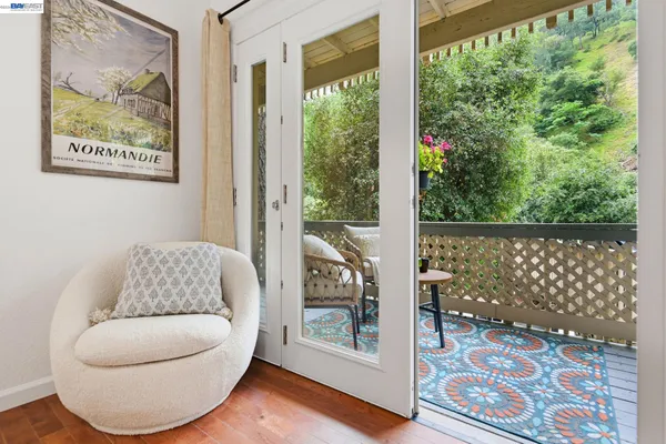 a living room with furniture and a floor to ceiling window