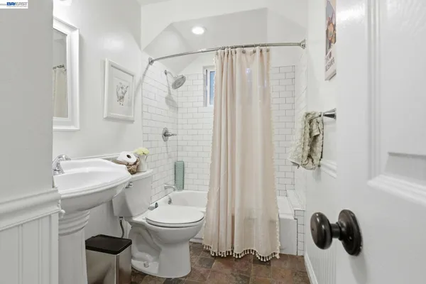a bathroom with a toilet sink and shower