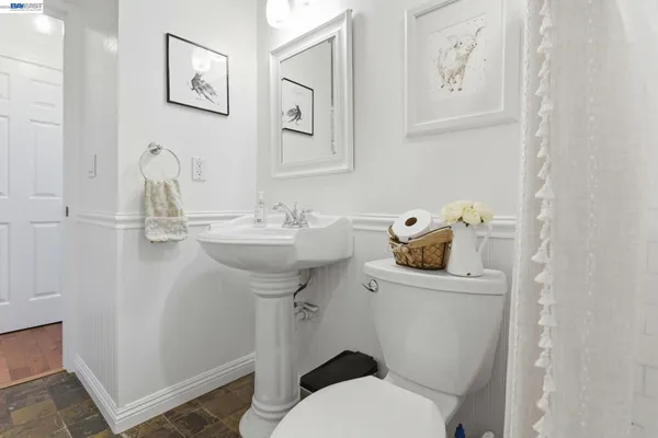 a bathroom with a sink mirror and toilet