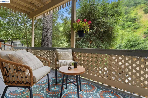 a view of a chairs and table in the balcony