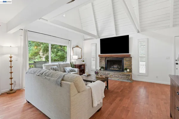 a living room with furniture a flat screen tv and a fireplace