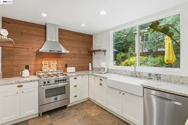 a kitchen with a stove sink and window