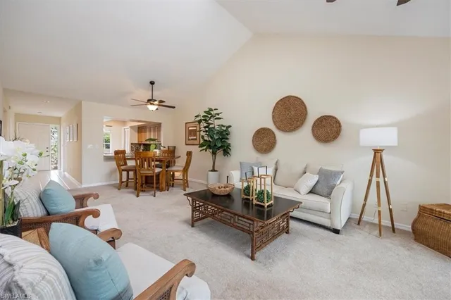 a living room with furniture and chandelier