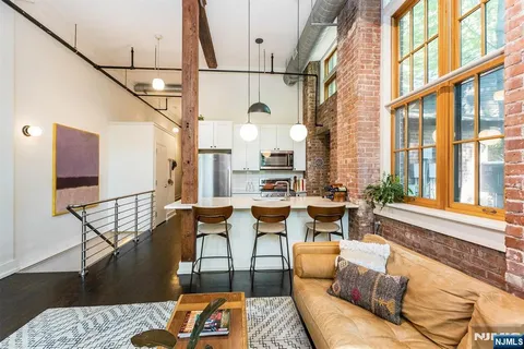 a kitchen with granite countertop a stove top oven microwave and cabinets