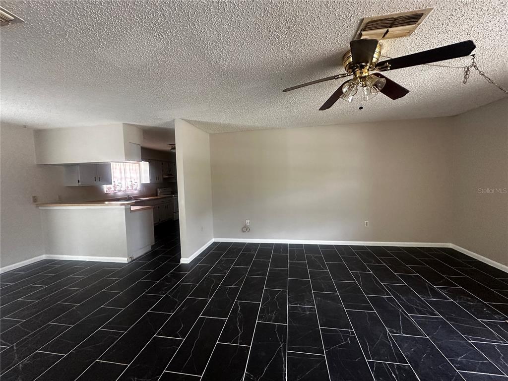 66 Silver Lane Ocala, FL 34472 - Photo 2 of 10 a view of a room with a floor to ceiling window and stainless steel appliances