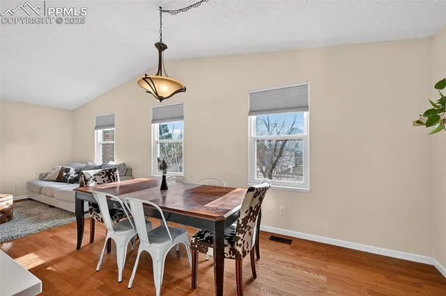 a view of a dining room with furniture window and wooden floor