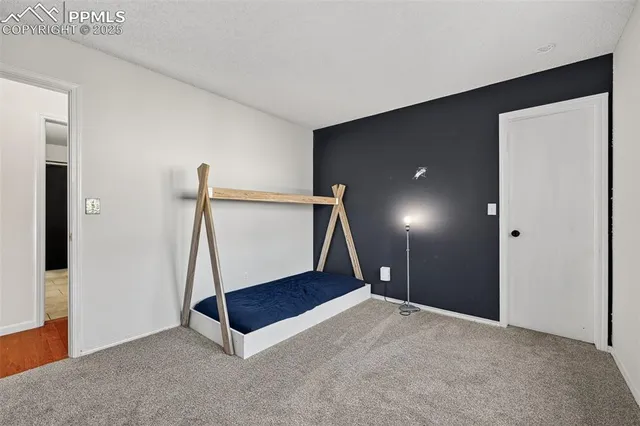 a view of an empty room with a fireplace and a window