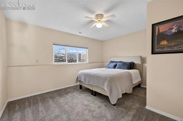 a bedroom with a bed and a painting