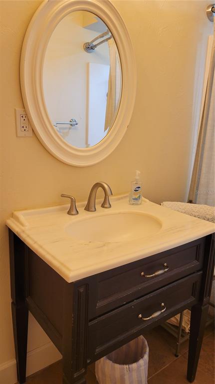 3932 Sunshine Avenue Sarasota, FL 34231 - Photo 12 of 17 a bathroom with a sink and a mirror