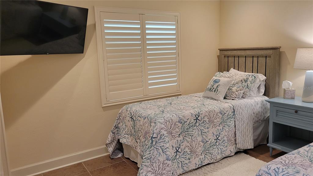 3932 Sunshine Avenue Sarasota, FL 34231 - Photo 15 of 17 a bedroom with a bed and a flat screen tv