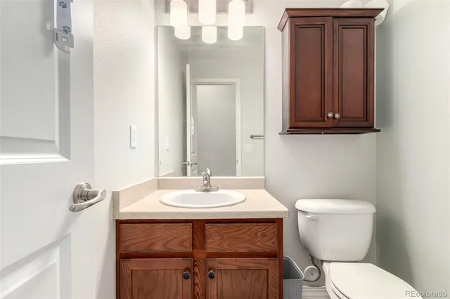 a bathroom with a toilet a sink and mirror
