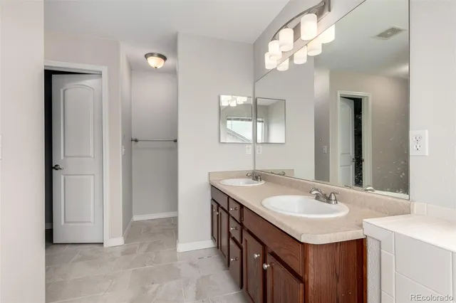 a bathroom with a sink a light fixture and a mirror