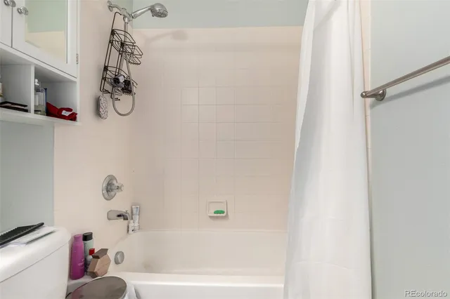 a bathroom with a bathtub a sink and a shower