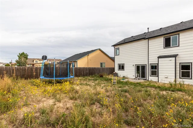 a backyard of a house with wooden fence