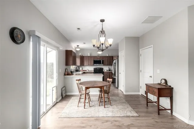 a view of a dining room with furniture and a chandelier