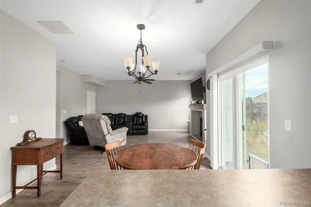 a living room with furniture a chandelier and a window