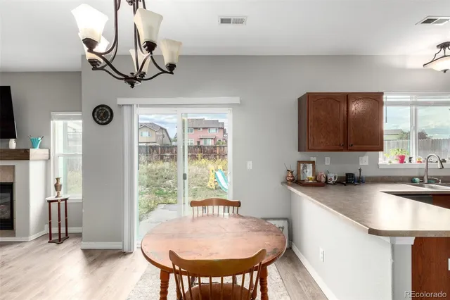 a kitchen with stainless steel appliances granite countertop a sink a microwave cabinets and wooden floor