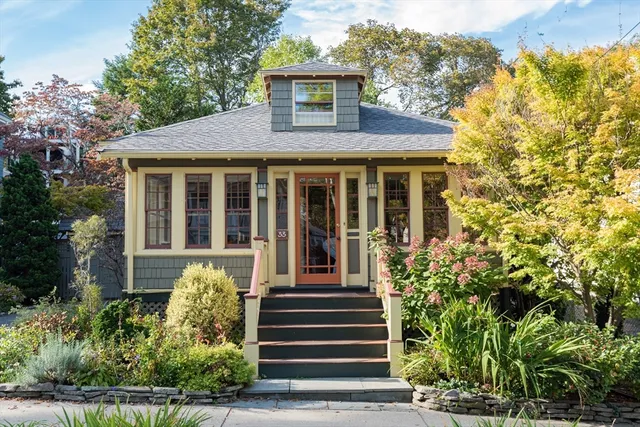 a front view of a house with a garden