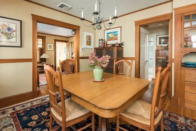 a dining room with furniture and chandelier