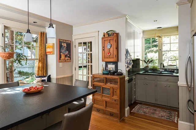 a kitchen with stainless steel appliances a dining table chairs and couches