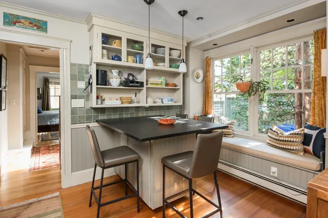 a dining room with a table chairs and wooden floor