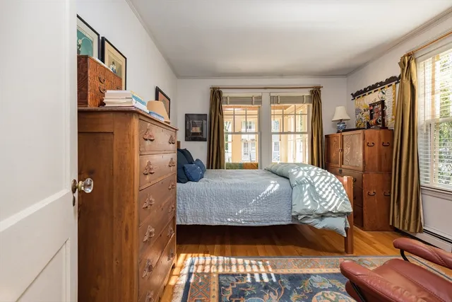a bed sitting in a bedroom next to a window