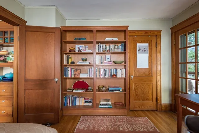 a living room with furniture a rug and a book shelf