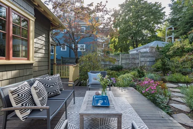 a view of a patio with couches table and chairs and potted plants