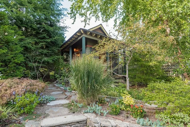 a front view of a house with plants