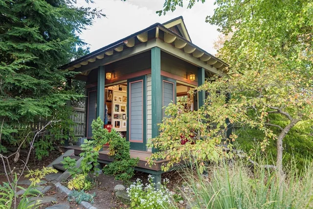 a view of a backyard with pathway and plants