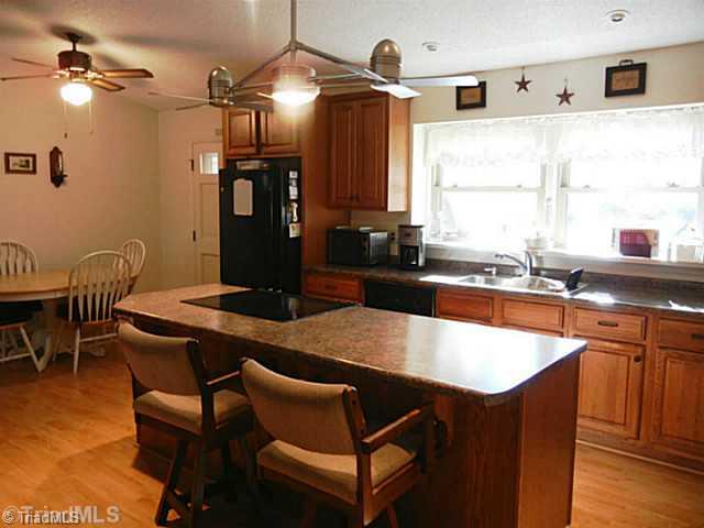 1258 Leake Memorial Church Road Germanton, NC 27019 - Photo 16 of 16 Kitchen. Open floor plan with cathedral ceilings. Kitchen was remodeled in 2006 with new cabinets, counters, appliances, flooring and light fixture over the island.