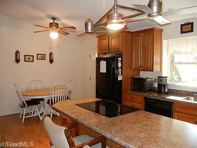 1258 Leake Memorial Church Road Germanton, NC 27019 - Photo 5 of 16 Kitchen. A closer view of the kitchen, there s a fireplace to the left and double windows over the sink for natural light. Double hung vinyl tilt windows in 2006 have a lifetime warranty.