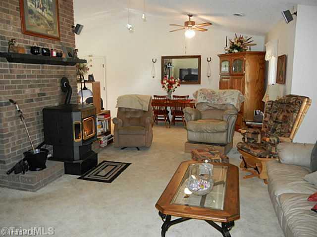 1258 Leake Memorial Church Road Germanton, NC 27019 - Photo 8 of 16 Living Room. Living room has a bay window, vaulted ceiling, pellet stove to supplement the heat pump, ceiling fan and a mantle.