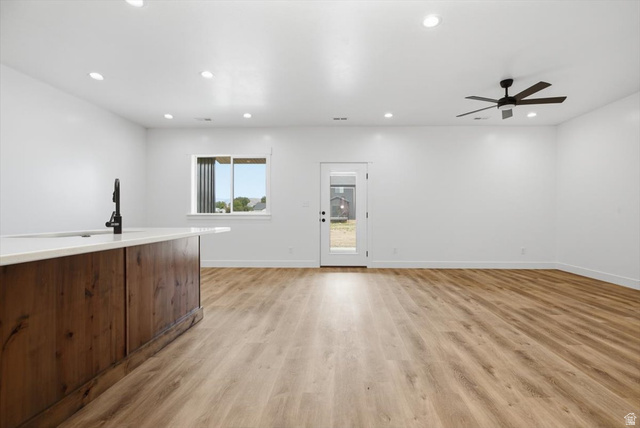 164 North 400 East Preston, ID 83263 - Photo 4 of 21 Open-concept living space with wood-finish flooring, recessed lighting, and a contemporary ceiling fan