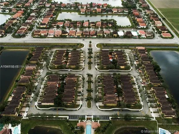 an aerial view of water body with boats and trees