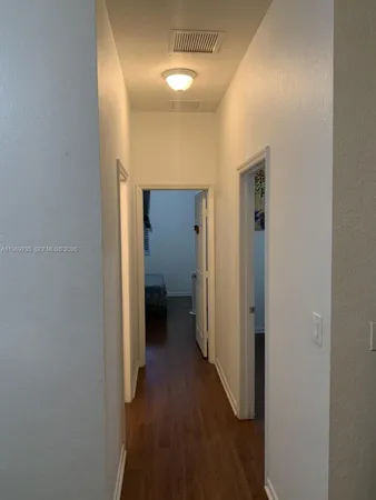 a view of a hallway with a room