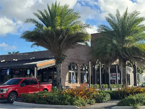 a view of a cars park in front of building