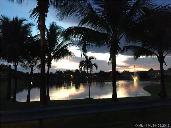 a view of swimming pool and lake from window