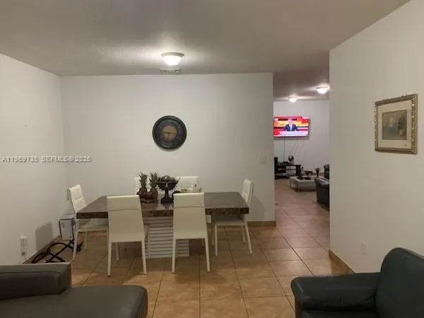 a dining room with furniture and a rug