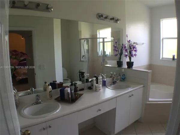 a bathroom with a sink double vanity and a mirror