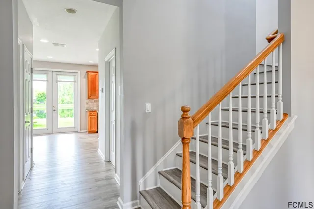 a view of an entryway with wooden floor and stairs