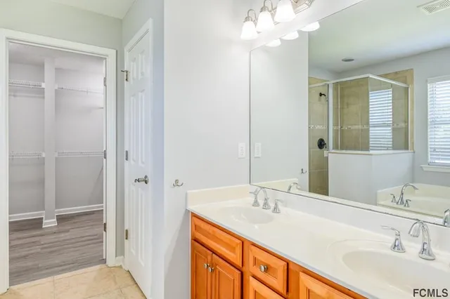 a bathroom with a sink double vanity and a mirror