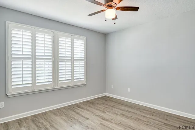 wooden floor in an empty room with a window