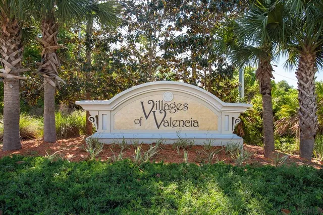 a sign of golf club on a tree