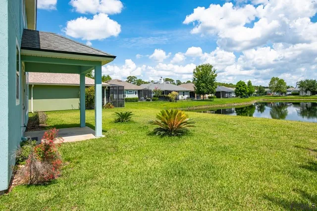 a view of a swimming pool with a yard